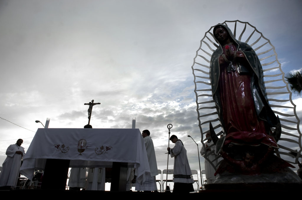A statue of Our Lady of Guadalupe sits on a stage during a Nov. 19 Mass celebrated near the U.S.-Mexico border fence in Tijuana, Mexico. The Mass and a procession with a statue of Our Lady of Guadalupe were a call to remember and pray for migrants and were led by Archbishop Francisco Moreno Barron of Tijuana. (CNS photo/David Maung)