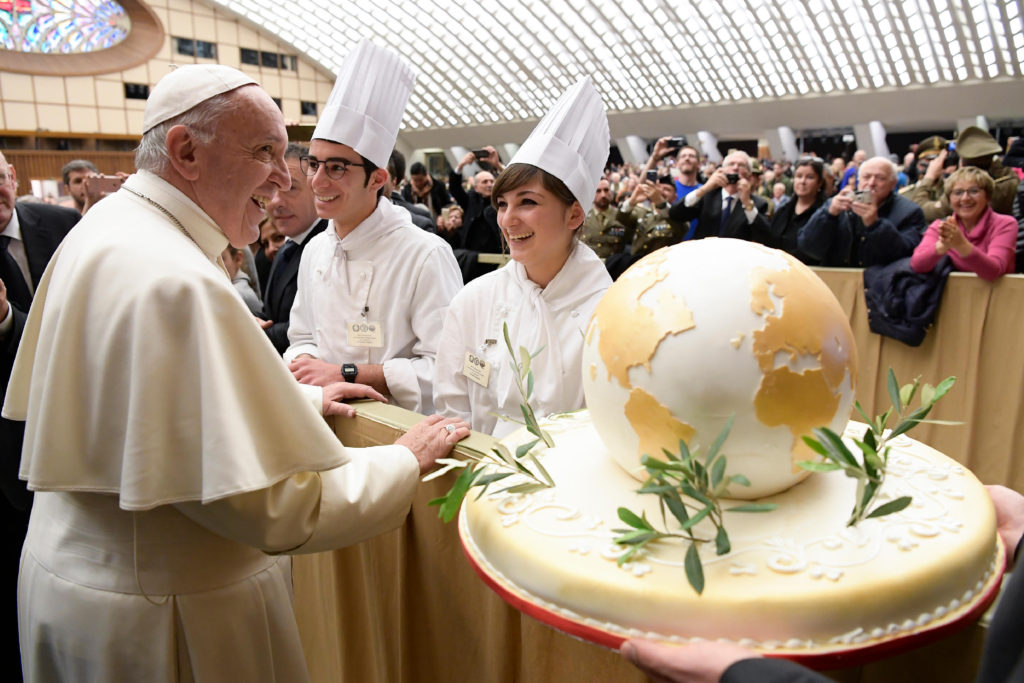 Pope Francis accepts a birthday cake from chefs during his general audience in Paul V hall at the Vatican Dec. 14. The pope will turn 80 Sept. 17. (CNS photo/L'Osservatore Romano, handout) 