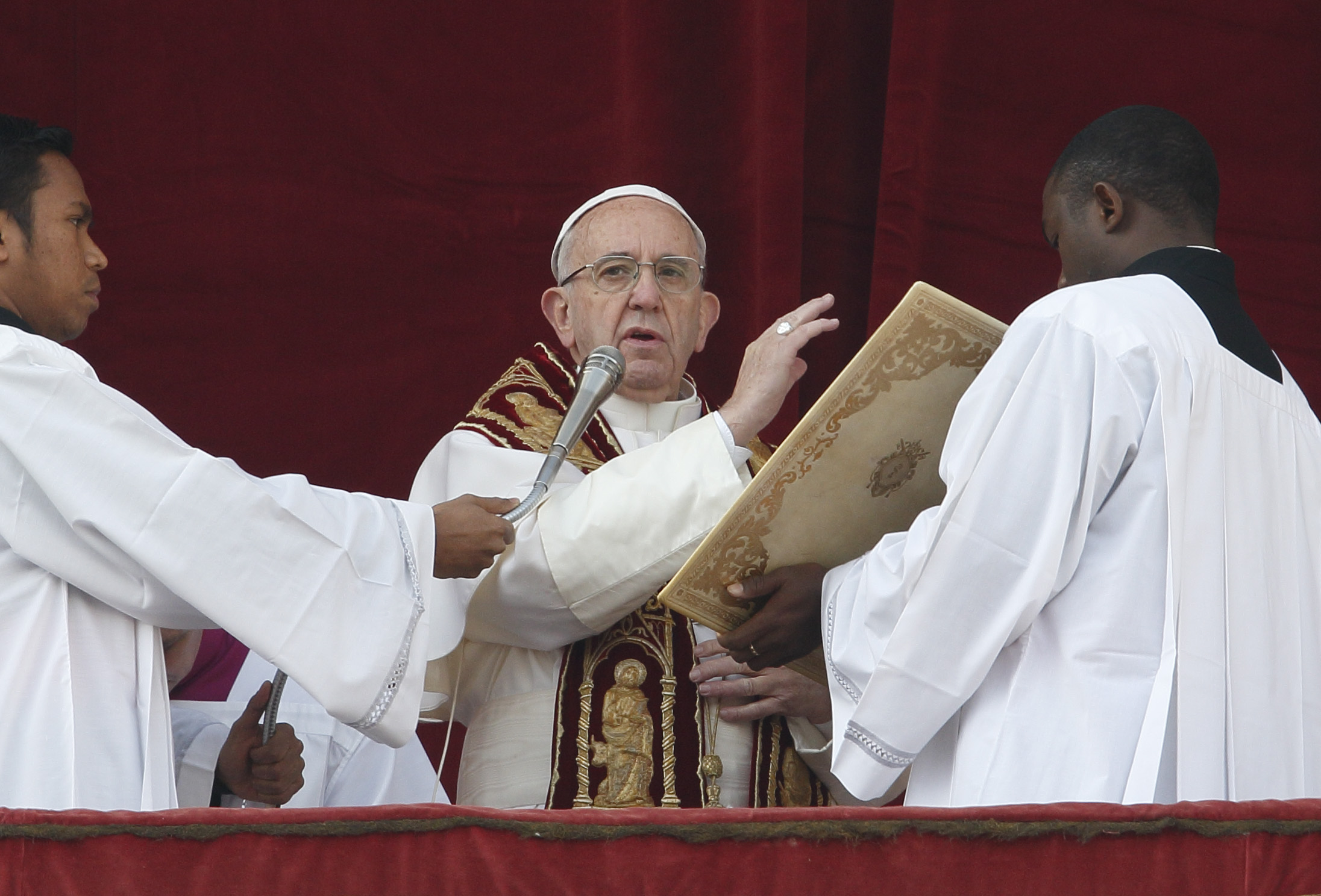 Pope Francis delivers his Christmas blessing "urbi et orbi" (to the city and the world) from the central balcony of St. Peter's Basilica at the Vatican Dec. 25. (CNS photo/Paul Haring)