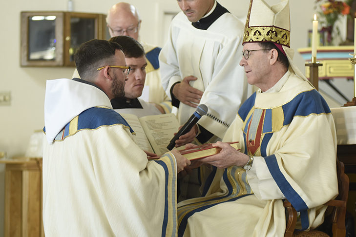 Br. Athanasius Fornwalt, FHS, receives the Book of the Gospels from Bishop Thomas J. Olmsted during his diaconal ordination Mass. As a deacon, Br. Athanasius will be a minister of the Word. (Photo courtesy of Catholic Media Ministry)