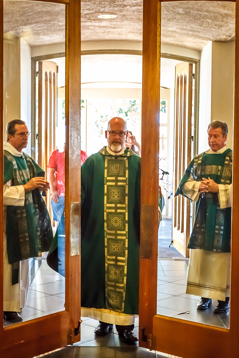 Fr. John Lankeit, rector of Ss. Simon and Jude Cathedral, closes the Holy Doors of Mercy at the cathedral following the 9 a.m. Mass Nov. 13. (John Bering/CATHOLIC SUN)