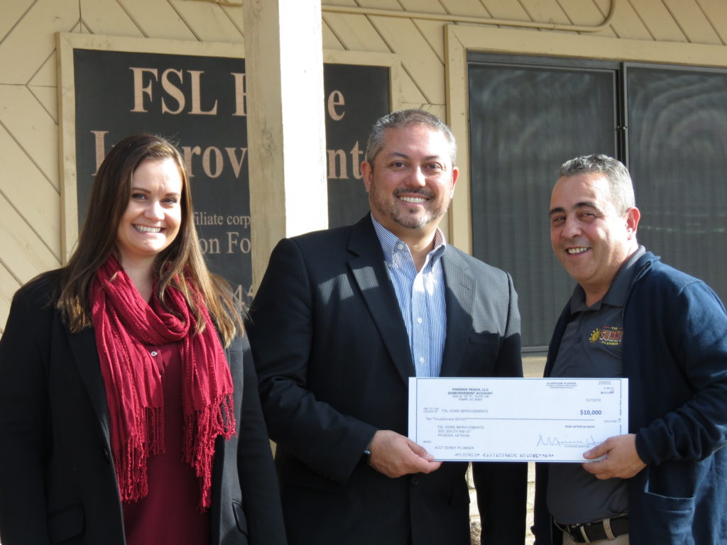 Katie Martin, Home Improvements Director and Dan Burke, Chairman of Goettl pose for a photo with a representative from The Sunny Plumber during a check presentation. (courtesy photo)