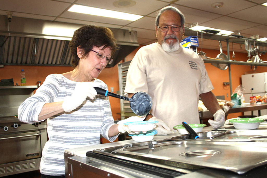 Volunteers from St. Jerome Parish in Phoenix dish out the tasty fare for the hungry who visit each Friday for a free meal that features two kinds of soup. The parish began the program during Lent but the organizers decided to keep it going for at least another six months. (Ambria Hammel/CATHOLIC SUN)