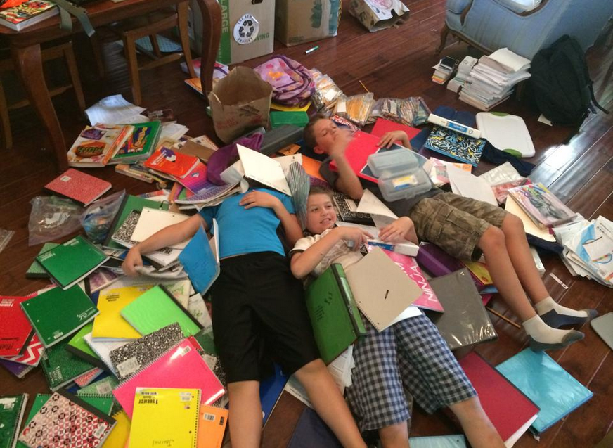 Boys, including Nathan and Seamus Simmons, right, rest while sorting through school supplies fellow Ss. Simon and Jude students donated to the Re: Pack effort. (courtesy photo)