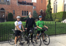 Father Christoper Heanue, administrator and a parochial vicar of Holy Child Jesus Church in Richmond Hill, N.Y., poses for a photo with two biking companions, Paul Cerni, left, and Tom Chiafolo.