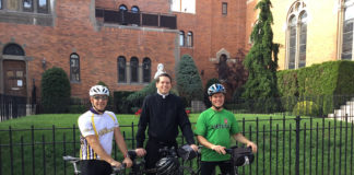 Father Christoper Heanue, administrator and a parochial vicar of Holy Child Jesus Church in Richmond Hill, N.Y., poses for a photo with two biking companions, Paul Cerni, left, and Tom Chiafolo.