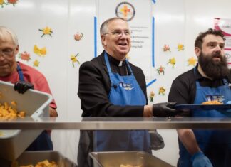 Bishop Dolan visits and serves at Andre House